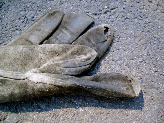 folded glove with a hole in the pad of the index finger