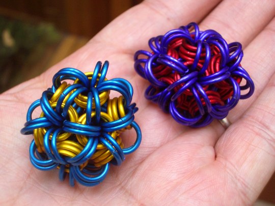 two colorful balls made out of chain links