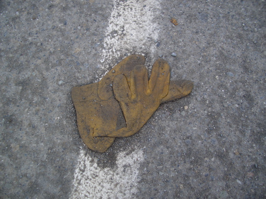 tan leather work glove on a fog line