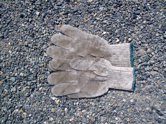 pair of knit cotton gloves, palms up, thumbs and index fingers overlapping