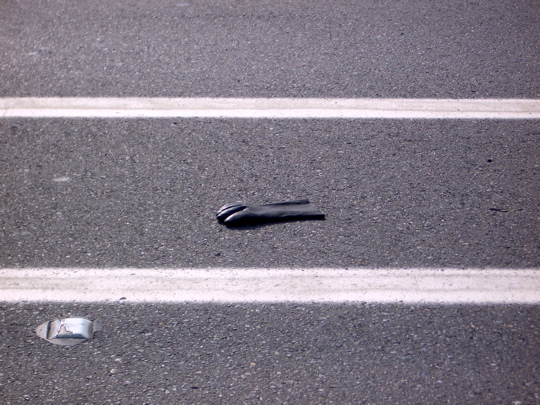 black rubber glove in a bike lane
