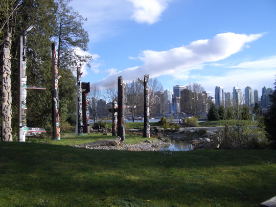 totem poles against Vancouver, BC skyline